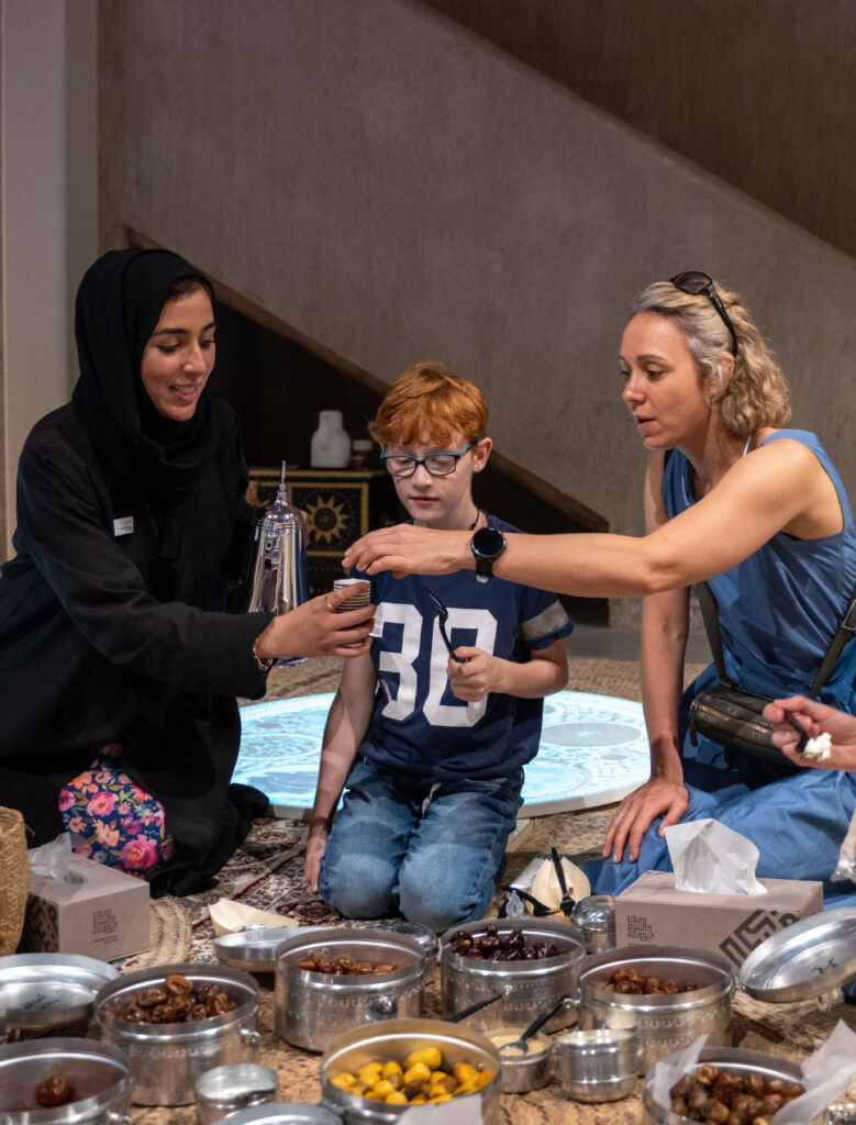 Image of an Emirati lady displaying the food of the UAE as part of a cultural program devised by Talents UAE